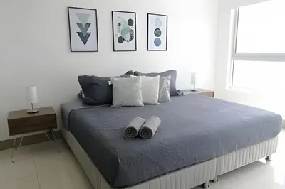 a bedroom with a bed with two pairs of slippers at Luxury 2B apartment, Amazing View in Cartagena de Indias