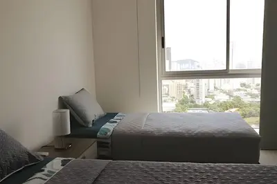 a bedroom with two beds and a large window at Espectacular vista en la mejor zona del Laguito in Cartagena de Indias