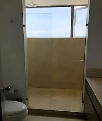 a bathroom with a glass shower door with a toilet at Breathtaking ocean view, central location in Cartagena de Indias