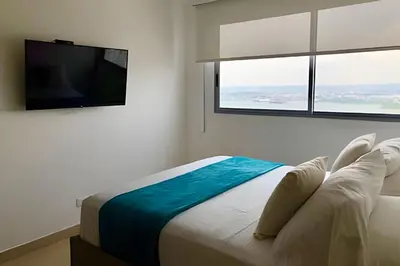 a bedroom with a bed and a flat screen tv at Breathtaking ocean view, central location in Cartagena de Indias