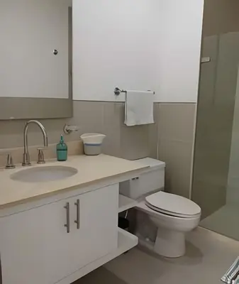 a bathroom with a toilet and a sink and a mirror at Precioso apto cama King y con salida a playa in Cartagena de Indias