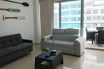 a living room with two couches and a table at Precioso apto cama King y con salida a playa in Cartagena de Indias