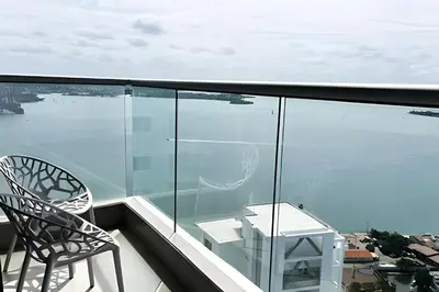 a balcony with two chairs and a view of the water at Ocean Majesty, Luxury Haven close to Walled City in Cartagena de Indias