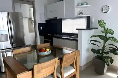 a kitchen with a glass table with chairs and a plant at Ocean Majesty, Luxury Haven close to Walled City in Cartagena de Indias