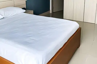 a bed in a room with a white bedsheet at Ocean Majesty, Luxury Haven close to Walled City in Cartagena de Indias