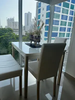 a white table and chairs in a room with a window at Charming Loft near the Beach in Cartagena de Indias