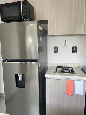 a kitchen with a stainless steel refrigerator and a microwave at Charming Loft near the Beach in Cartagena de Indias