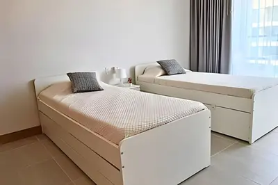 two beds in a room with a window at Lujo y privacidad, Vista y salida directa al mar in Cartagena de Indias