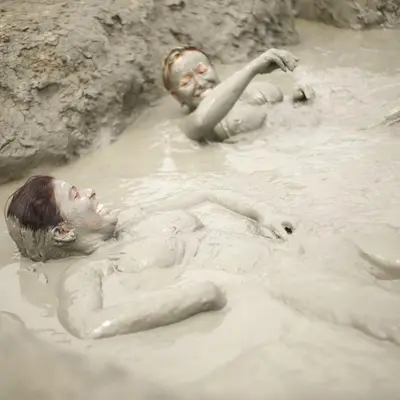 a man and a woman laying in the water at Monkey Afro Hostel in San Antero