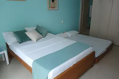 a bedroom with a large bed with blue walls at Coastal Charm with Mesmerizing Seaside Views in Cartagena de Indias
