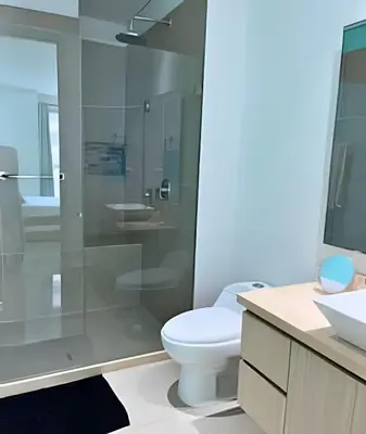 a bathroom with a toilet and a glass shower at Coastal Charm with Mesmerizing Seaside Views in Cartagena de Indias