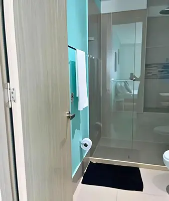 a bathroom with a glass shower and a sink at Coastal Charm with Mesmerizing Seaside Views in Cartagena de Indias