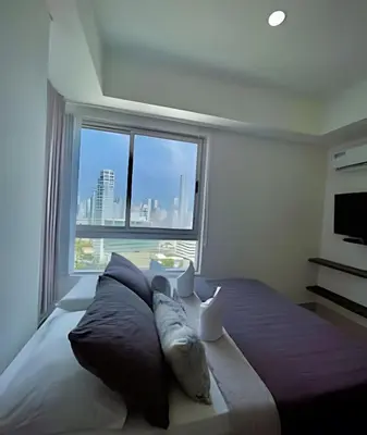 a bedroom with a large bed with a large window at Amazing Ocean View, 2B in Bocagrande in Cartagena de Indias