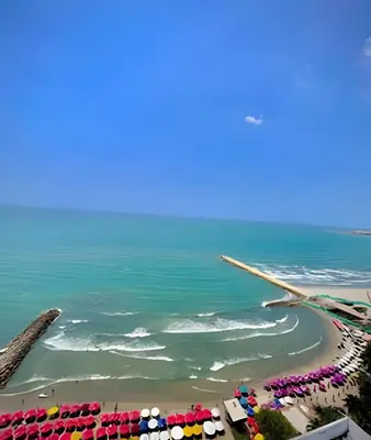 an aerial view of a beach with umbrellas and the ocean at Amazing Ocean View, 2B in Bocagrande in Cartagena de Indias