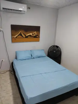 a bedroom with a blue bed in a room at Backhouse gallery in Cartagena de Indias