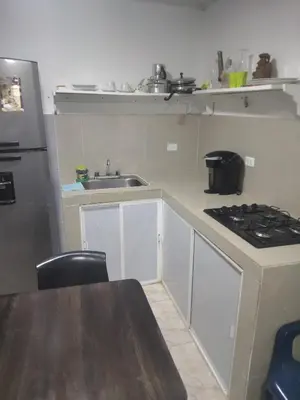 a small kitchen with a sink and a stove at Backhouse gallery in Cartagena de Indias