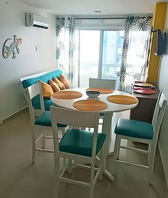 a dining room with a table and chairs at Precioso apto en el Laguito a pasos de la playa in Cartagena de Indias