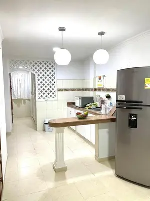 a kitchen with a counter and a refrigerator at Casa lujosa cerca al mar en cartagena in Cartagena de Indias