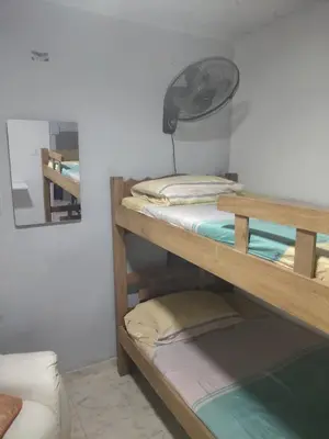 two bunk beds in a room with a fan at Back house gallery in Cartagena de Indias