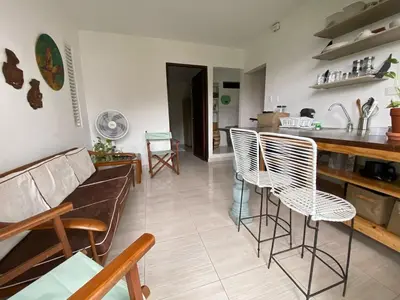 a living room with a couch and chairs and a kitchen at Northwest Hostings 4 in Cartagena de Indias