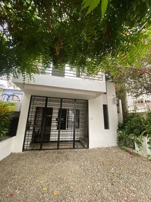 a white house with a gate in front of it at Northwest Hostings 4 in Cartagena de Indias