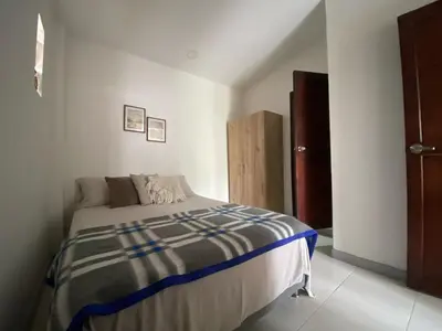 a bedroom with a bed in a white room at Northwest Hostings 4 in Cartagena de Indias