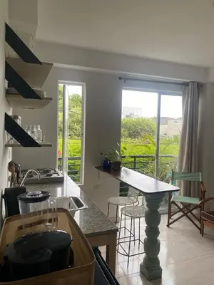 a kitchen with a counter and a table with chairs at Northwest Hostings 4 in Cartagena de Indias