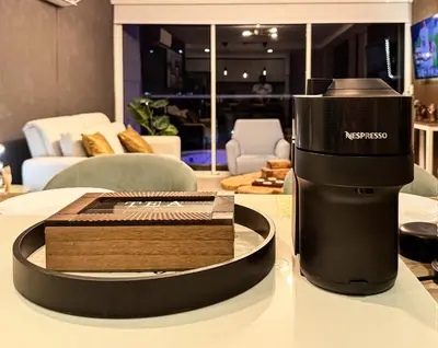 a coffee machine on a table in a living room at Dominique Luxury - 1 BR - Private Jacuzzi - 13th Floor in Cartagena de Indias