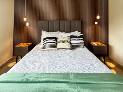 a bedroom with a large bed with two night stands at Dominique Luxury - 1 BR - Private Jacuzzi - 13th Floor in Cartagena de Indias