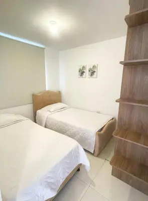 two beds in a small room with two beds at Comfortable and central apartment in Bquilla in Barranquilla