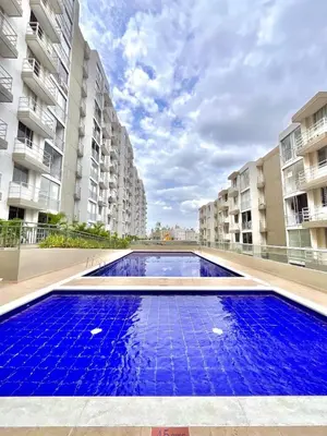 an empty swimming pool in the middle of two apartment buildings at Comfortable and central apartment in Bquilla in Barranquilla