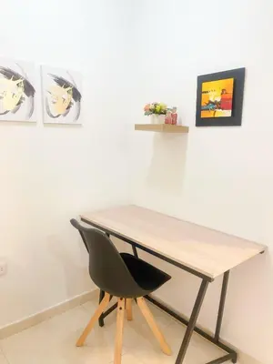 a desk with a black chair in front of a wall at Comfortable and central apartment in Bquilla in Barranquilla