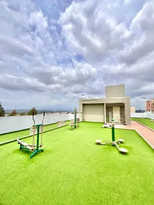 a building with a lawn with exercise equipment on it at Comfortable and central apartment in Bquilla in Barranquilla