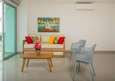 a living room with a couch and two chairs and a table at Apto De 3 Hab con Vista y Salida directa Al Mar in Estación El Salto