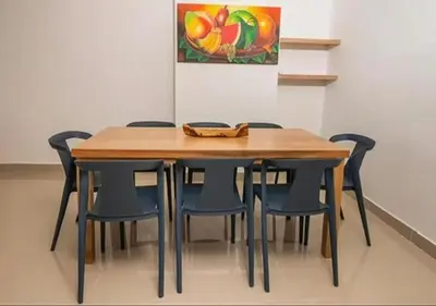 a wooden table and chairs in a room at Apto De 3 Hab con Vista y Salida directa Al Mar in Estación El Salto