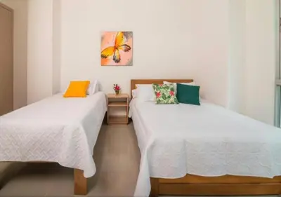 two beds sitting next to each other in a room at Apto De 3 Hab con Vista y Salida directa Al Mar in Estación El Salto
