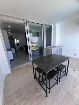 a dining room with a wooden table and chairs at Apartasuite en Cartagena in Cartagena de Indias