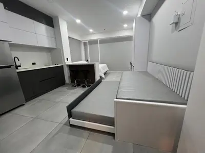 a large room with a bed and a kitchen at Apartasuite en Cartagena in Cartagena de Indias