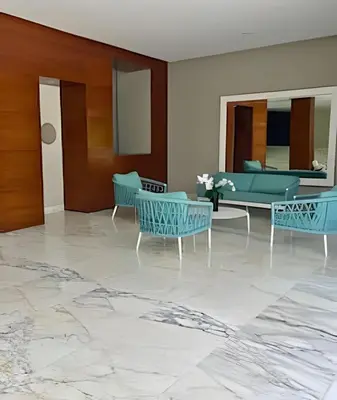 a lobby with blue chairs and a table at Beachfront Paradise with Pools and Spa in Cartagena de Indias