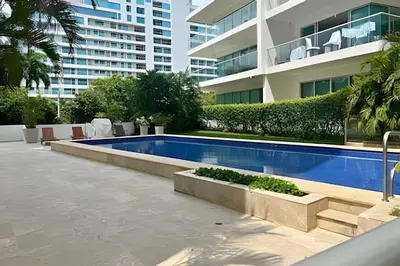 a swimming pool in front of a building at Beachfront Paradise with Pools and Spa in Cartagena de Indias