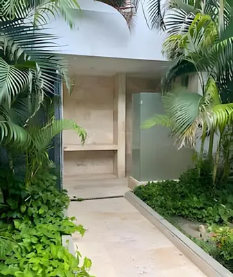 a house with a glass door between two plants at Beachfront Paradise with Pools and Spa in Cartagena de Indias