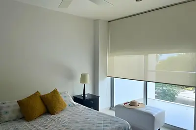 a bedroom with a bed and a large window at Beachfront Paradise with Pools and Spa in Cartagena de Indias