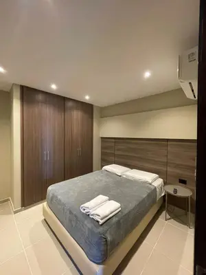 a bedroom with a bed with two towels on it at Apto Grand- Ithiel in Barranquilla