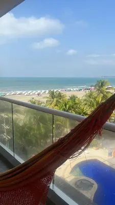 a hammock on a balcony with a view of the beach at Apartamento en la Boquilla, Cartagena in Cartagena de Indias