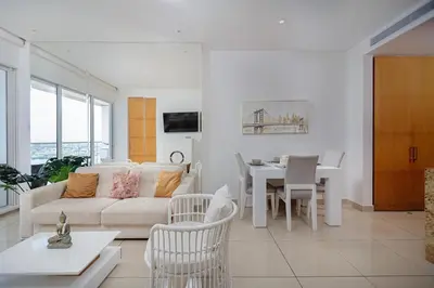 a living room with a couch and a dining room at luxury apartemt bay front 1bed 2703 in Cartagena de Indias
