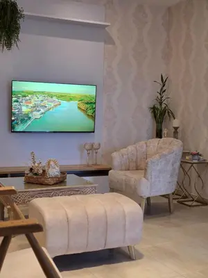 a living room with a tv and a chair and a table at Casa Chongui in Lorica