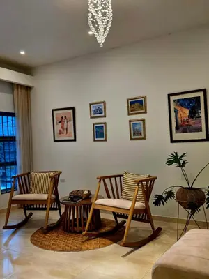a living room with two chairs and a table at Casa Chongui in Lorica