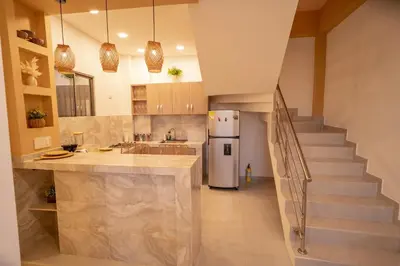 a kitchen with a staircase and a white refrigerator at Casa Chongui in Lorica