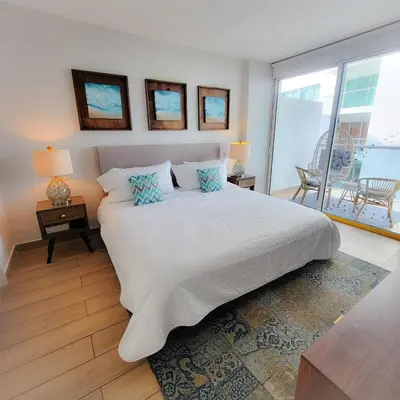 a bedroom with a large white bed and a balcony at View, exit to Playa Morros tres Cartagena in Cartagena de Indias