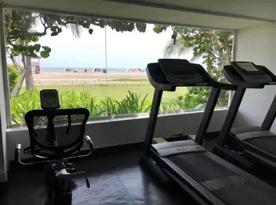 a gym with two exercise bikes and a large window at View, exit to Playa Morros tres Cartagena in Cartagena de Indias